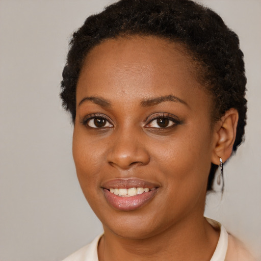 Joyful black young-adult female with short  brown hair and brown eyes