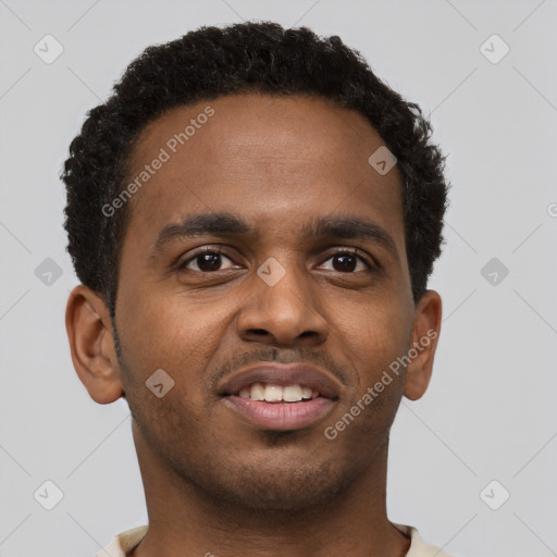 Joyful black young-adult male with short  brown hair and brown eyes