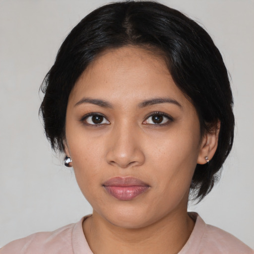 Neutral latino young-adult female with medium  black hair and brown eyes