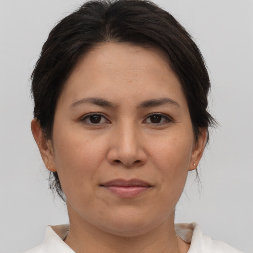Joyful asian adult female with short  brown hair and brown eyes