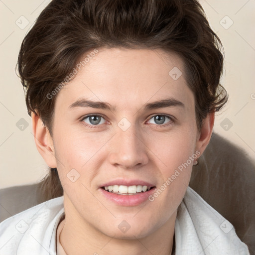 Joyful white young-adult female with short  brown hair and grey eyes