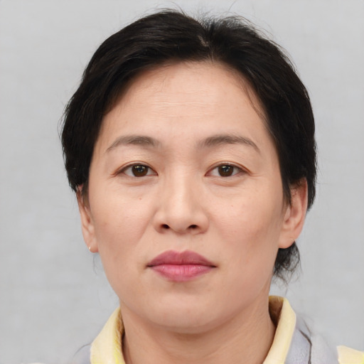 Joyful white adult female with medium  brown hair and brown eyes