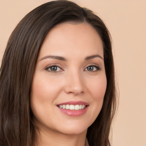 Joyful white young-adult female with long  brown hair and brown eyes