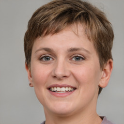 Joyful white young-adult female with short  brown hair and grey eyes