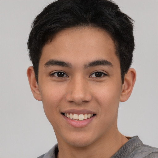 Joyful white young-adult male with short  black hair and brown eyes