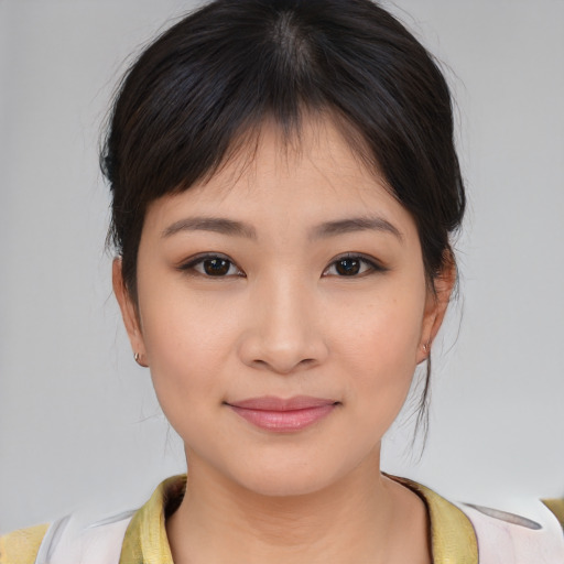 Joyful asian young-adult female with medium  brown hair and brown eyes
