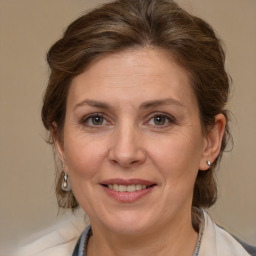 Joyful white adult female with medium  brown hair and brown eyes