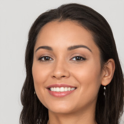 Joyful latino young-adult female with long  brown hair and brown eyes