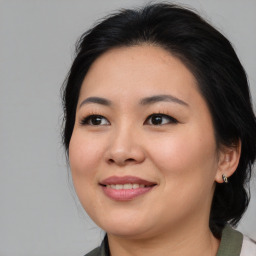 Joyful asian young-adult female with medium  brown hair and brown eyes