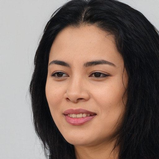 Joyful asian young-adult female with long  black hair and brown eyes