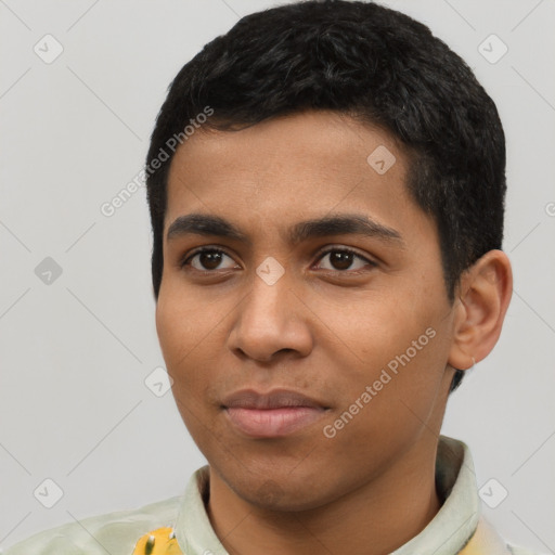 Joyful latino young-adult male with short  black hair and brown eyes