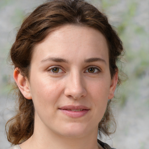 Joyful white young-adult female with medium  brown hair and green eyes