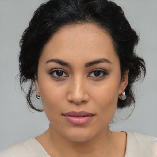 Joyful latino young-adult female with medium  brown hair and brown eyes