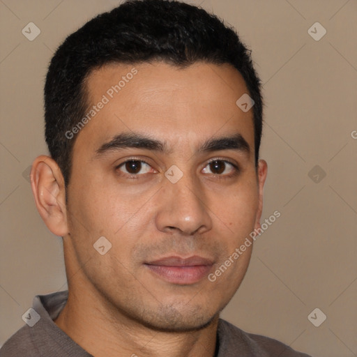 Joyful latino young-adult male with short  brown hair and brown eyes