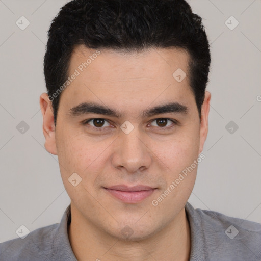 Joyful white young-adult male with short  black hair and brown eyes