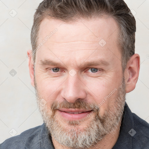 Joyful white adult male with short  brown hair and grey eyes