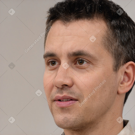 Joyful white adult male with short  brown hair and brown eyes