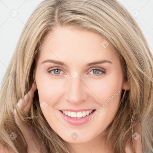 Joyful white young-adult female with long  brown hair and grey eyes