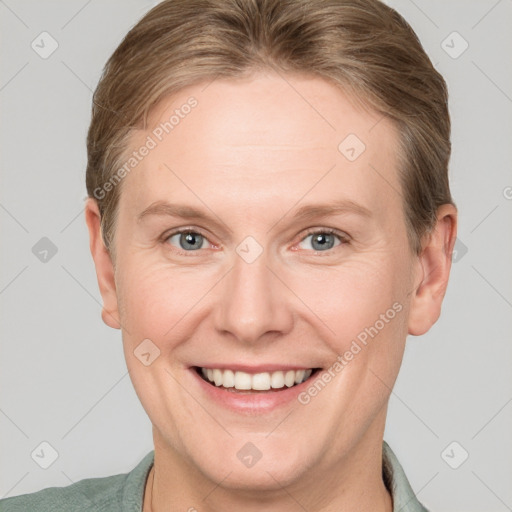 Joyful white adult female with short  brown hair and blue eyes