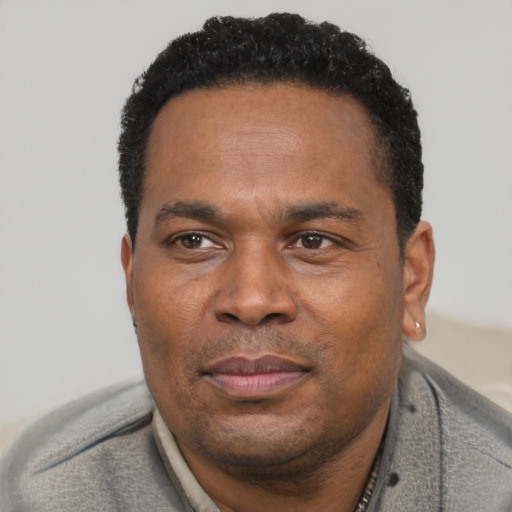 Joyful latino adult male with short  black hair and brown eyes