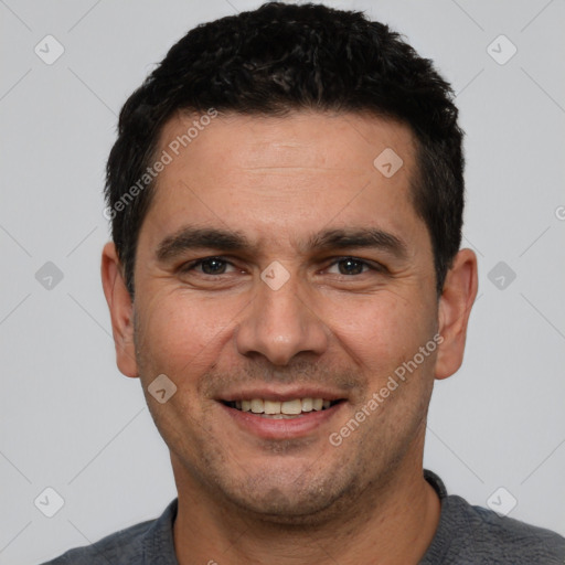 Joyful white young-adult male with short  black hair and brown eyes