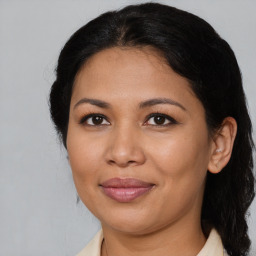 Joyful latino young-adult female with medium  brown hair and brown eyes