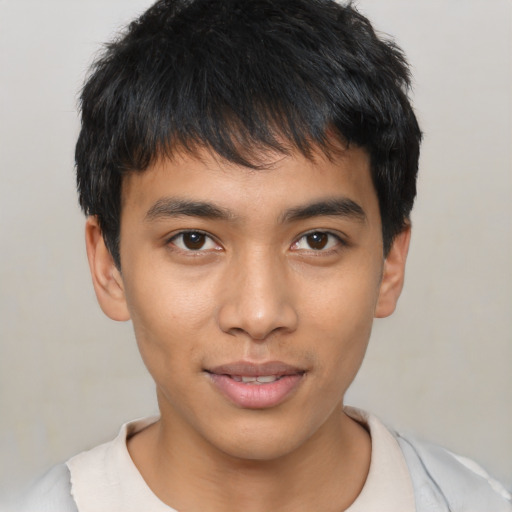 Joyful asian young-adult male with short  black hair and brown eyes