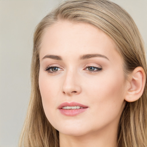 Joyful white young-adult female with long  brown hair and blue eyes