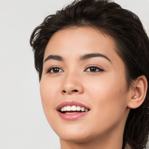 Joyful white young-adult female with long  black hair and brown eyes