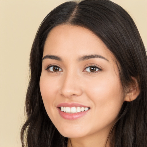 Joyful white young-adult female with long  brown hair and brown eyes