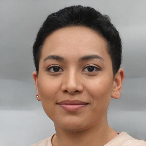 Joyful latino young-adult female with short  black hair and brown eyes