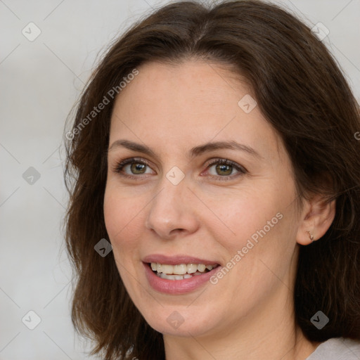 Joyful white adult female with medium  brown hair and brown eyes