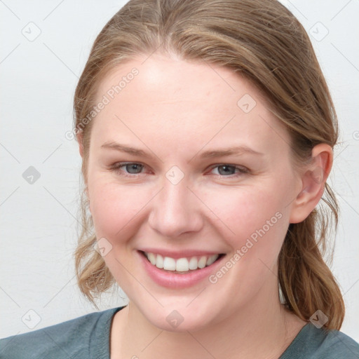 Joyful white young-adult female with medium  brown hair and blue eyes