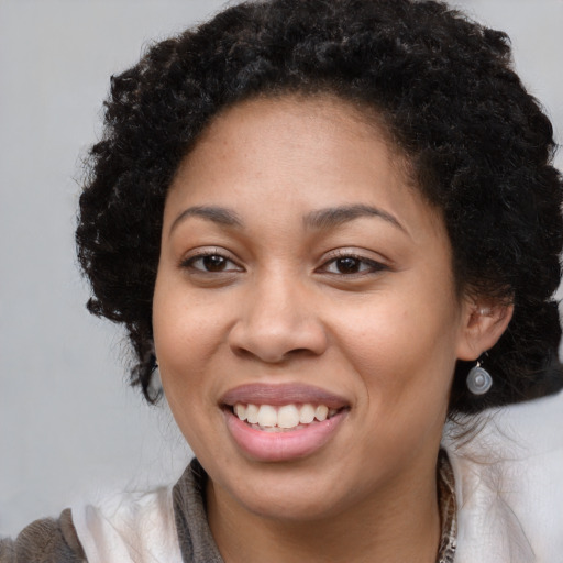 Joyful black young-adult female with medium  brown hair and brown eyes