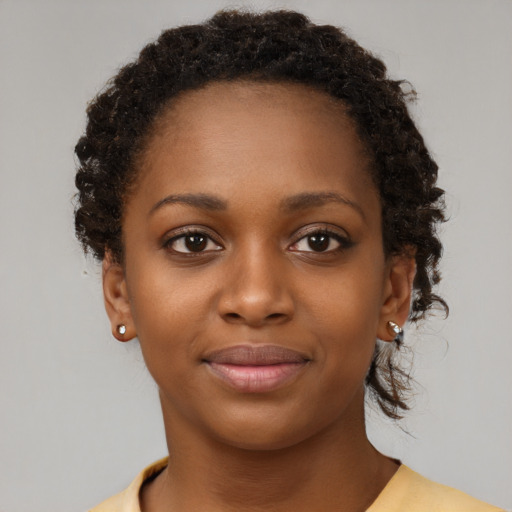 Joyful black young-adult female with short  brown hair and brown eyes