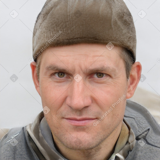 Joyful white adult male with short  brown hair and grey eyes