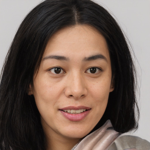 Joyful asian young-adult female with long  brown hair and brown eyes
