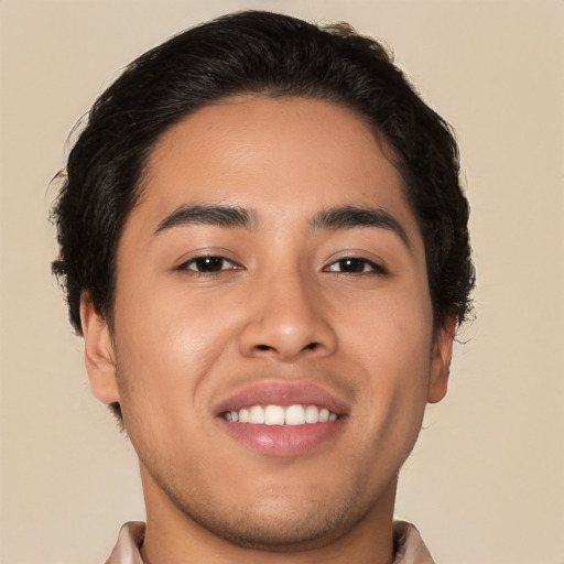 Joyful latino young-adult male with short  brown hair and brown eyes