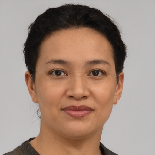 Joyful latino young-adult female with short  brown hair and brown eyes