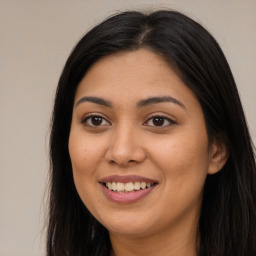 Joyful latino young-adult female with long  brown hair and brown eyes