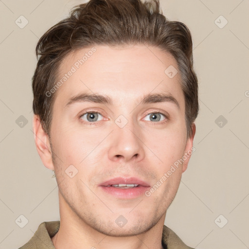 Joyful white young-adult male with short  brown hair and grey eyes