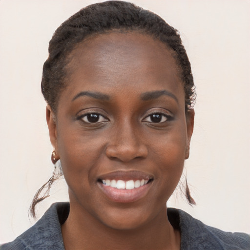 Joyful black young-adult female with medium  brown hair and brown eyes