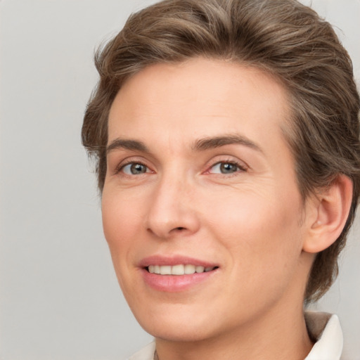 Joyful white young-adult female with medium  brown hair and green eyes