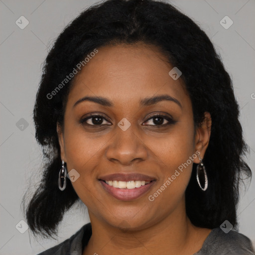 Joyful black young-adult female with long  brown hair and brown eyes