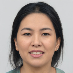 Joyful asian young-adult female with medium  brown hair and brown eyes