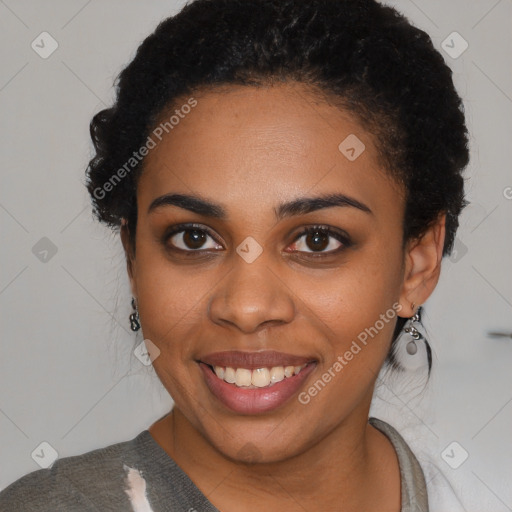 Joyful black young-adult female with short  black hair and brown eyes