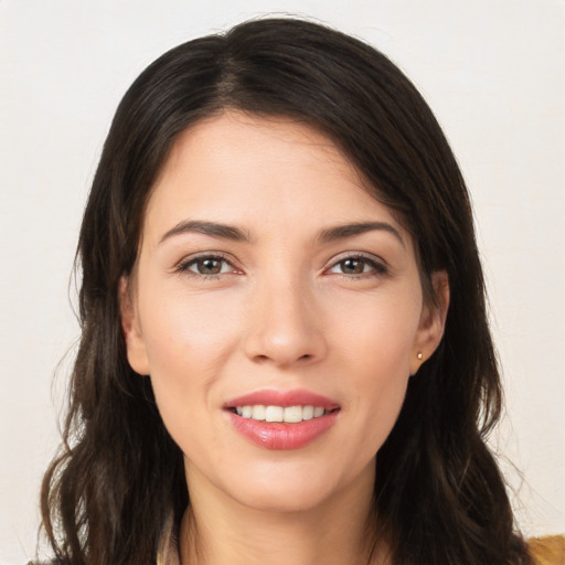 Joyful white young-adult female with long  brown hair and brown eyes