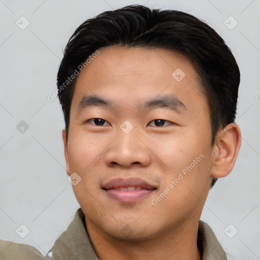 Joyful asian young-adult male with short  black hair and brown eyes