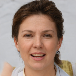 Joyful white adult female with medium  brown hair and brown eyes