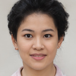 Joyful asian young-adult female with short  brown hair and brown eyes